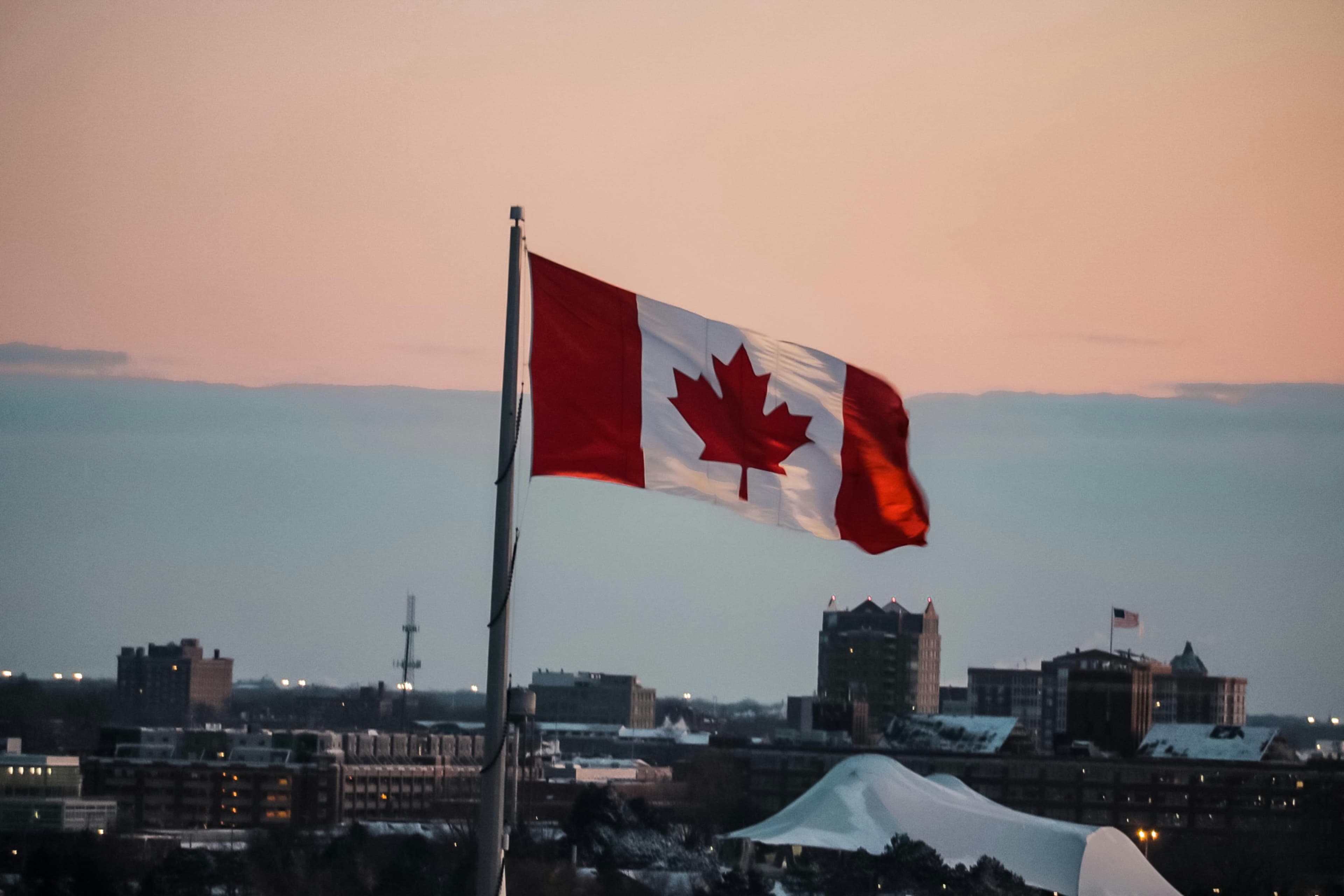 Canadian flag above city
